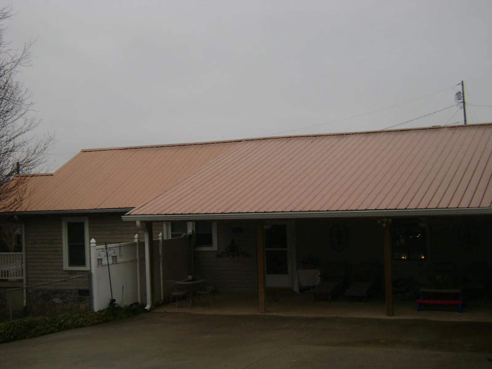 Copper toned metal roof over a wide covered patio in Mapleton